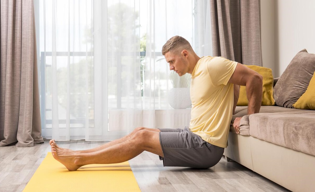 Man Exercising Home Using Couch at Core Concept