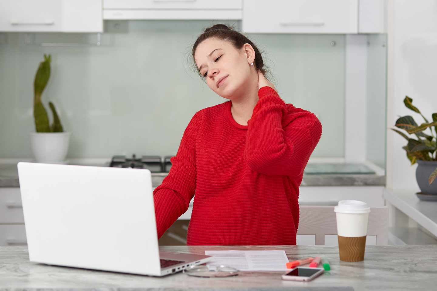 photo tired european woman keeps hand neck at core concept