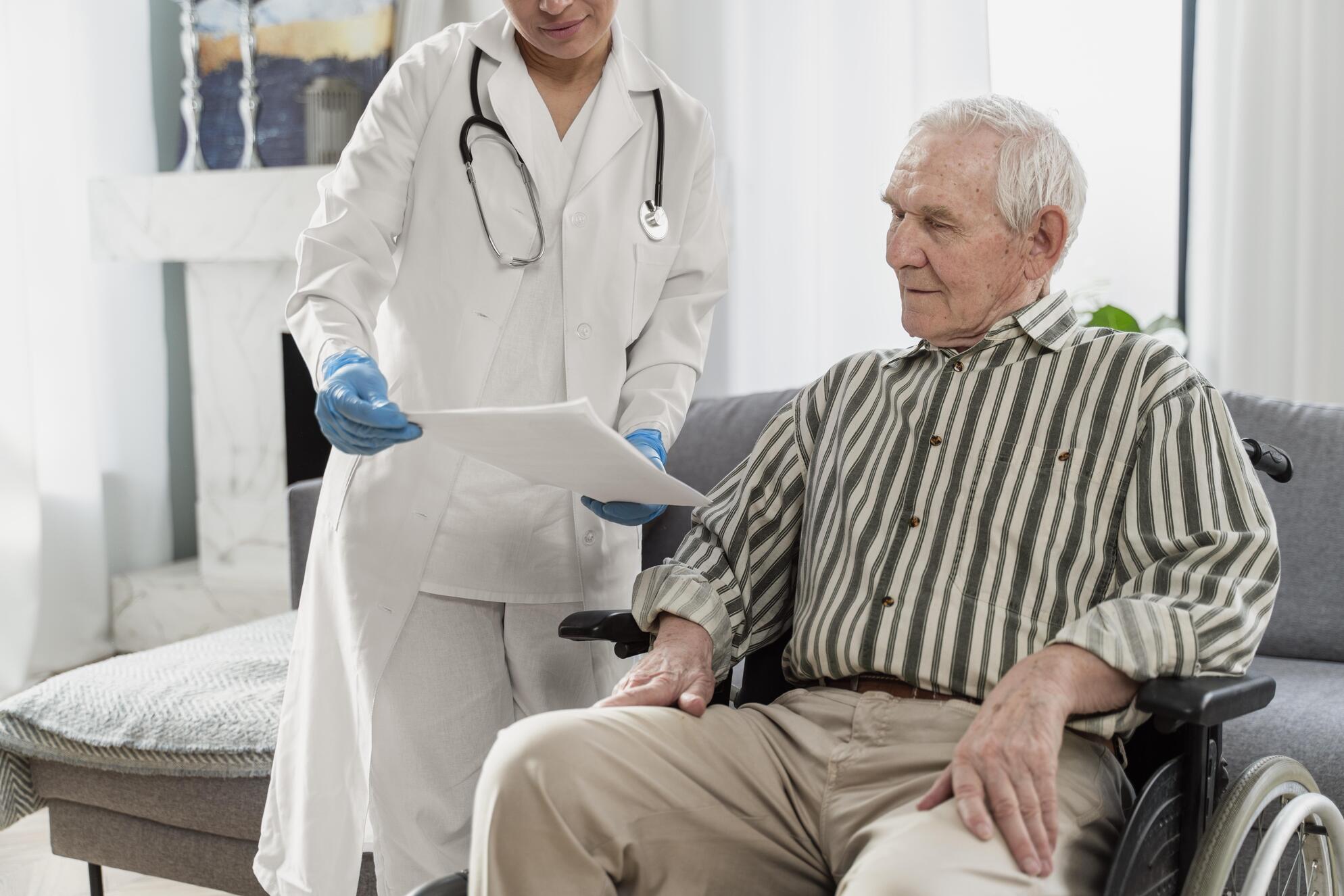 Doctor Talking Senior Man Indoors at Core Concept