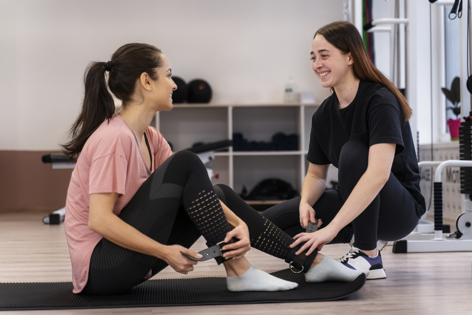 full shot woman with leg weights at Core Concept