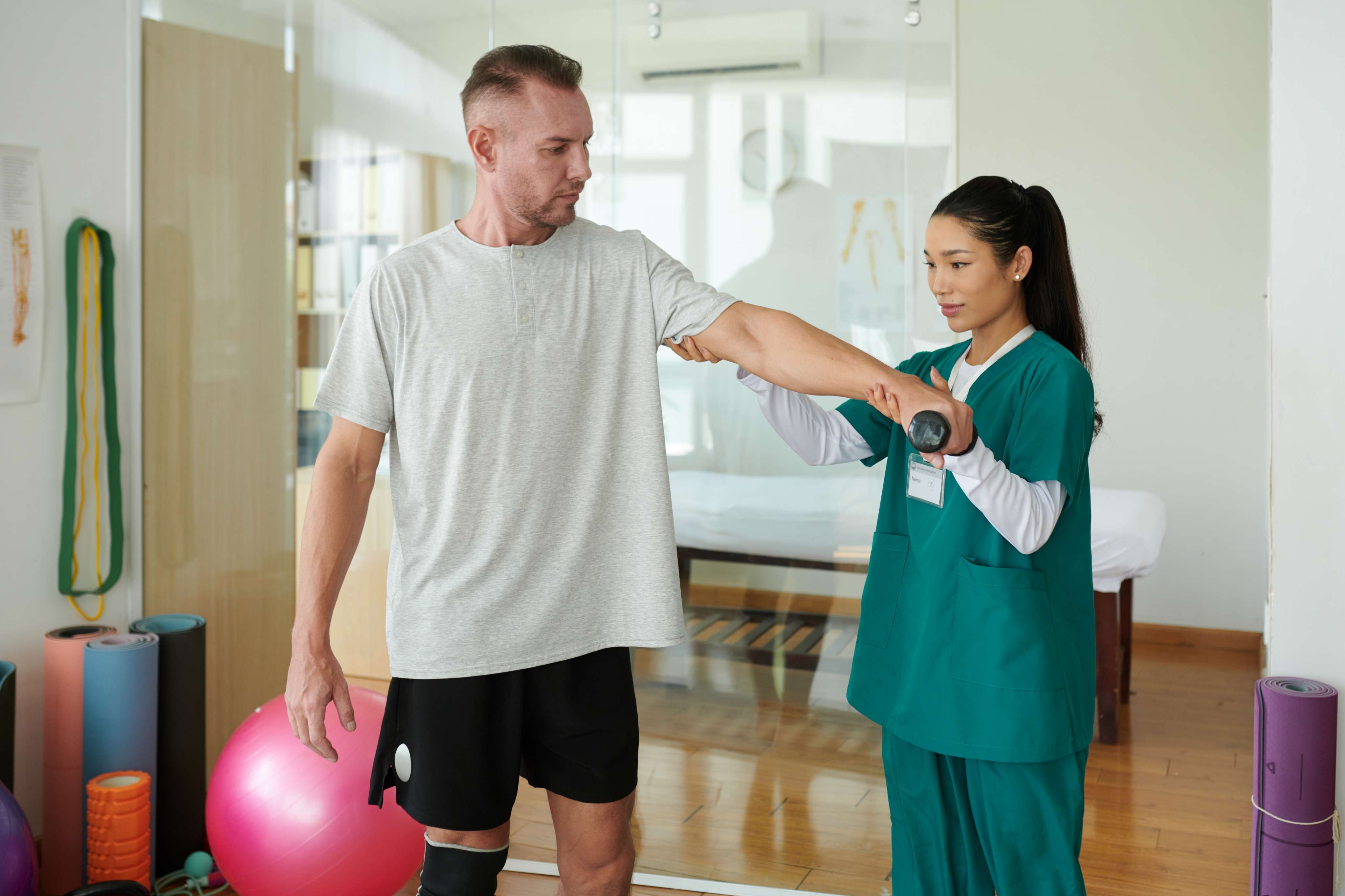 rehabilitation center worker helping client at Core Concept