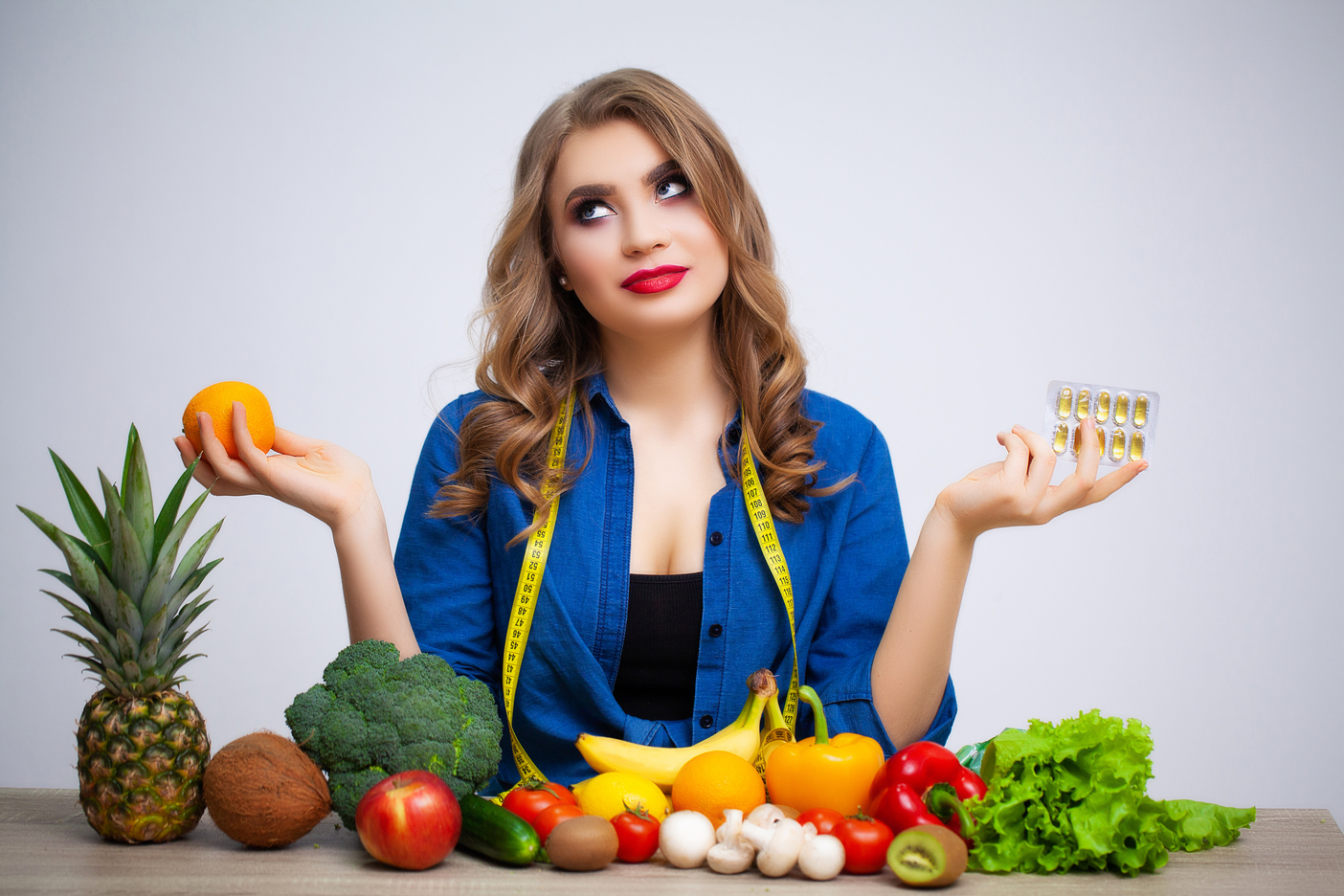 woman Table Holding Orange Pills Fruit Vegetables at Core Concept