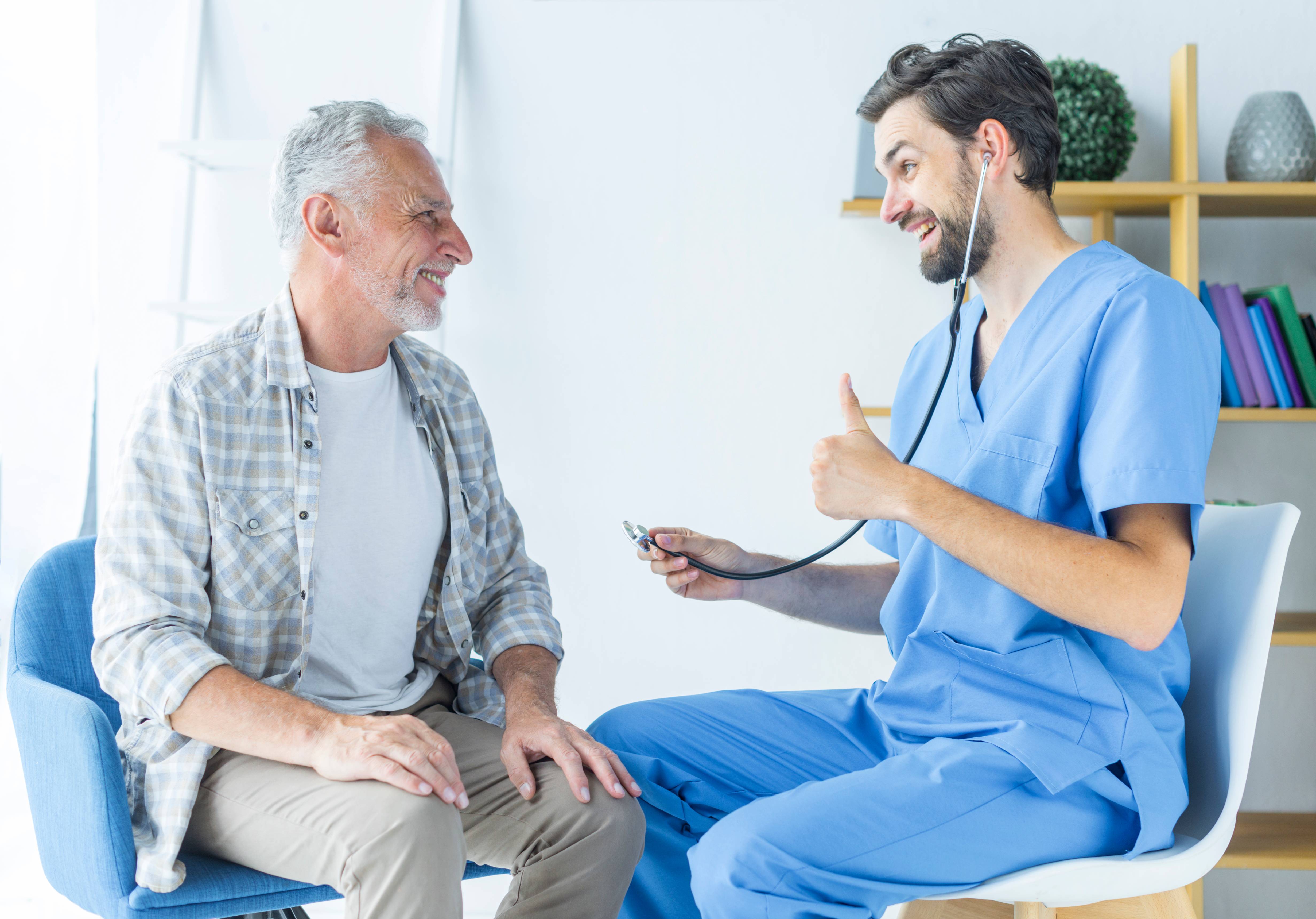 young doctor gesturing thumb up elderly patient at Core Concept